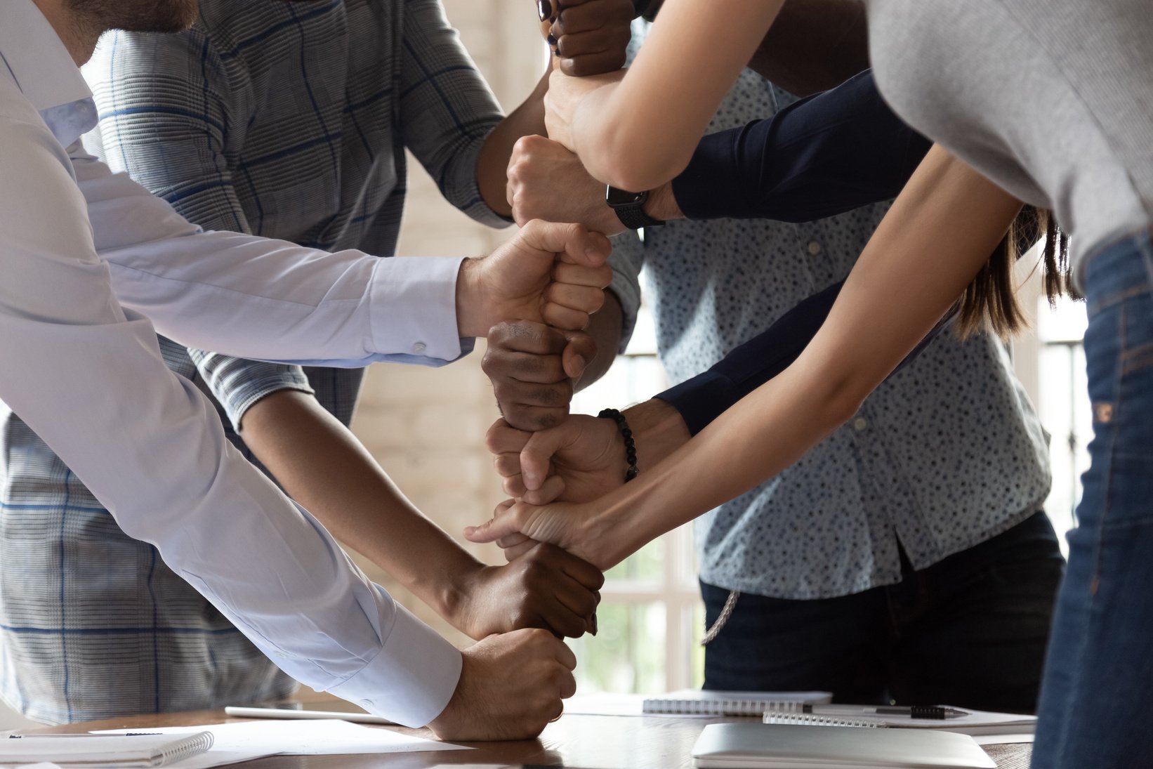 Diverse employees engaged in teambuilding activity at meeting